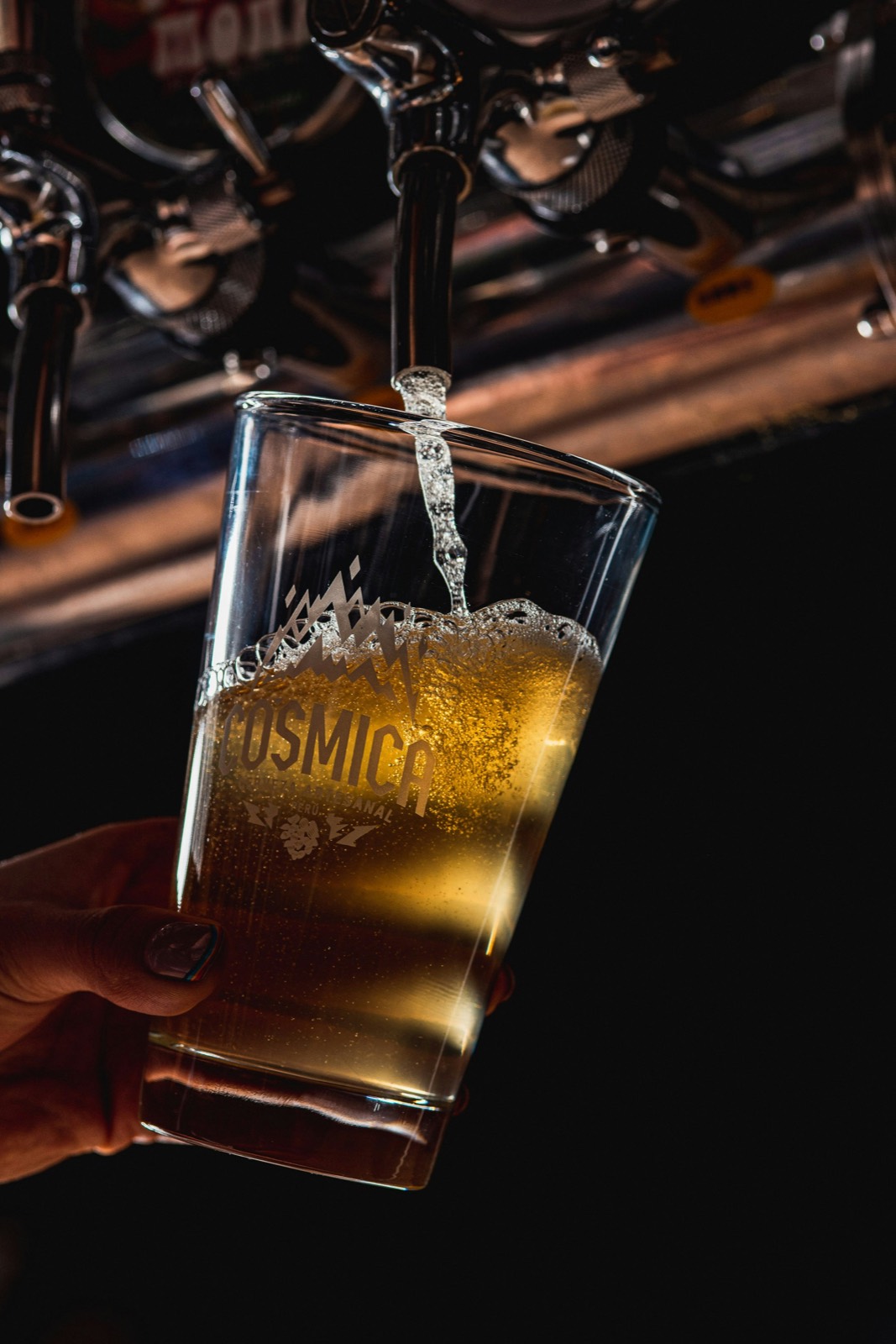 A pint glass filling from the tap.